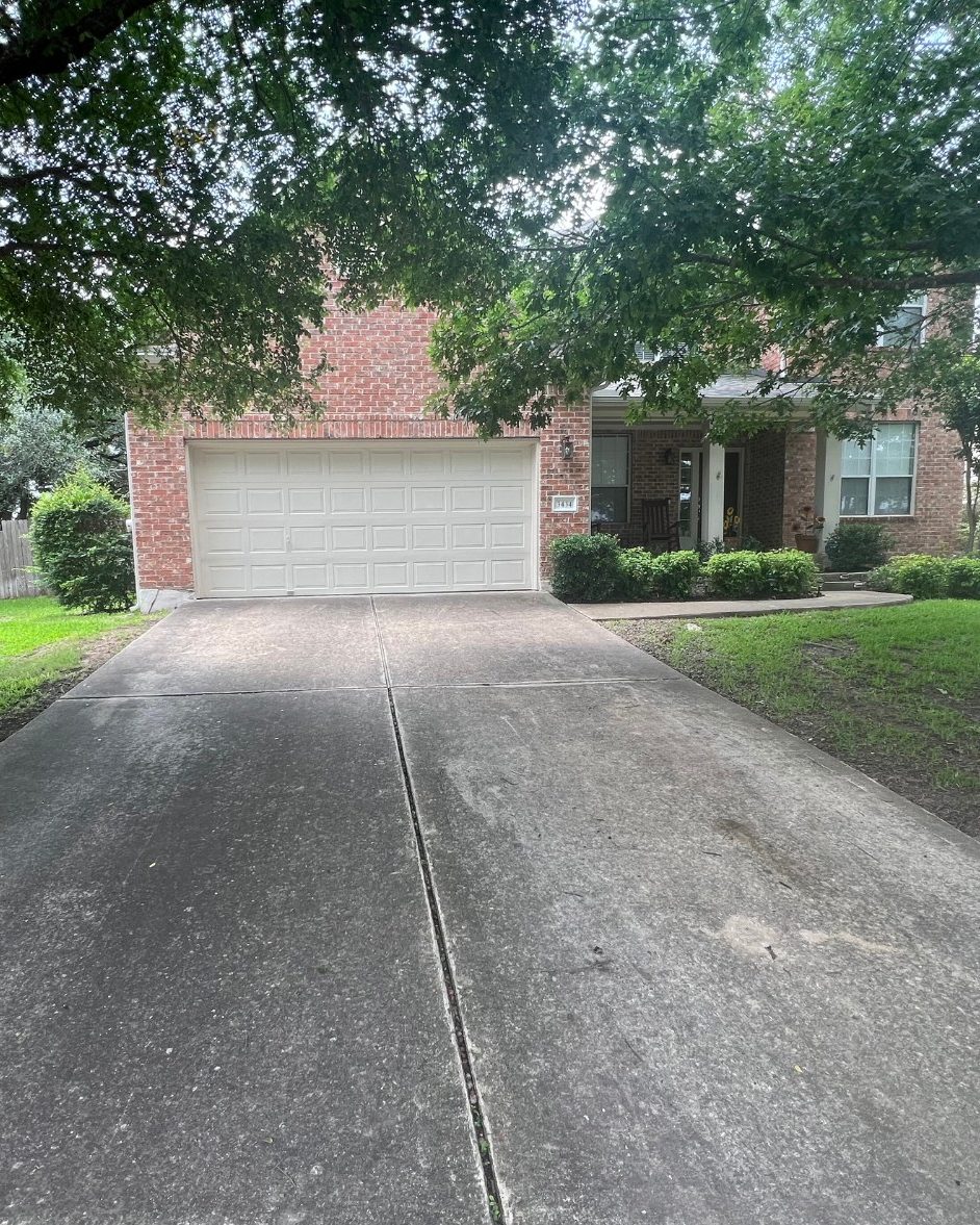 Before and after: concrete driveway pressure washed, Casa Care job (before photo)