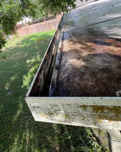 Before and after: flat-roof gutter flushed clean, Casa Care job (before photo)