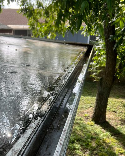 Before and after: leaf- and plant-packed flat-roof gutter cleared and flushed, Casa Care job (after photo)