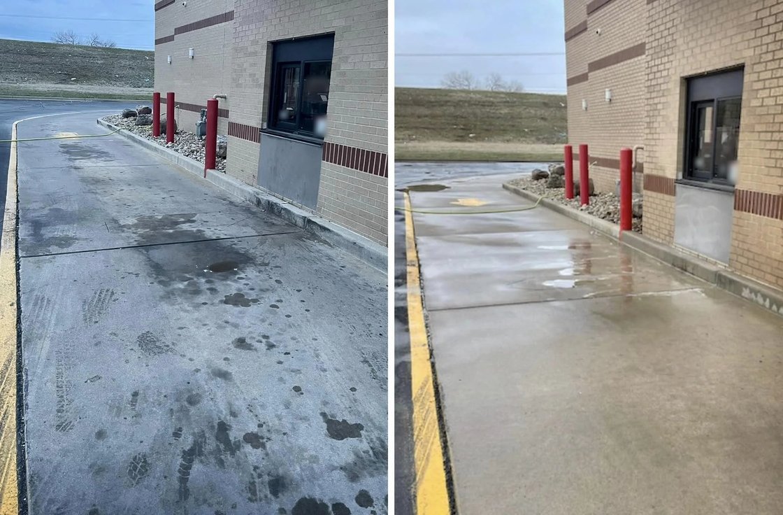 Drive-thru lane beside a tan brick building with a service window, shown before and after pressure washing: oil stains and tire marks on the concrete on the left, clean wet concrete on the right
