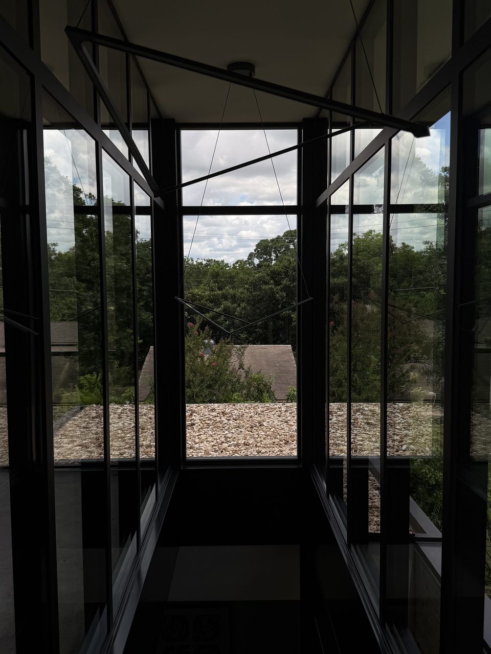 Modern glass-walled hallway with floor-to-ceiling windows, Casa Care job